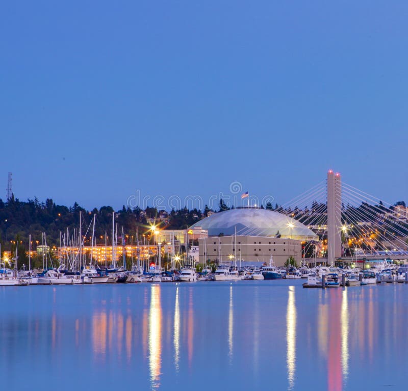 Tacoma dome with boats and Marina. City downtown at night.