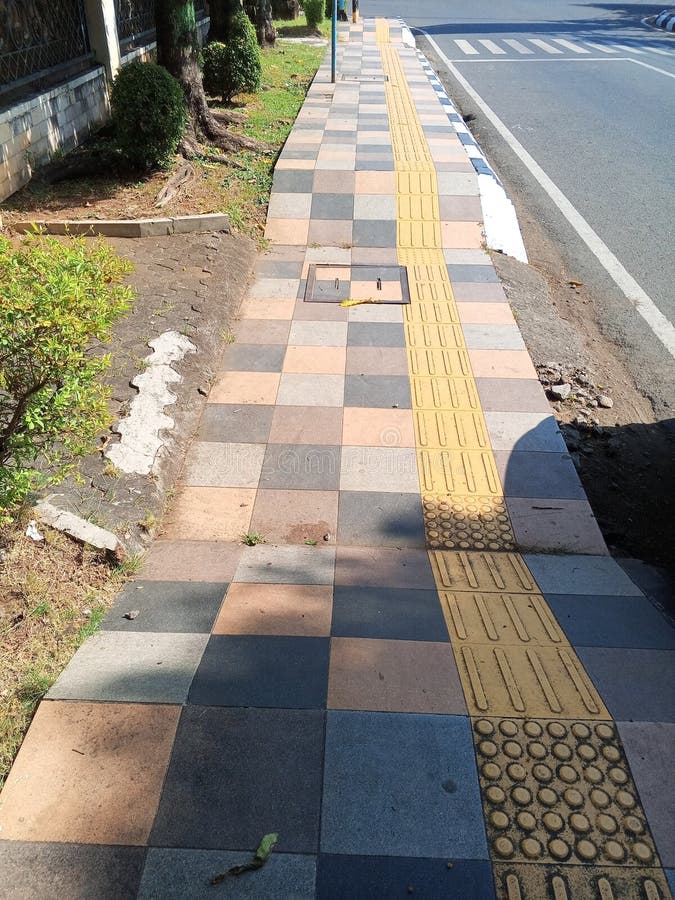 Tactile Paving on Checkered Sidewalk royalty free stock photos