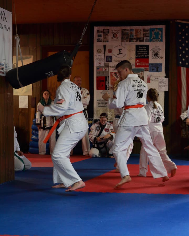 Tae Kwon Do students test for belts. Tae Kwon Do orange belts spar as they test for promotion in Cedar Rapids, Iowa royalty free stock photography Tae Kwon Do students test for belts. Tae Kwon Do orange belts spar as they test for promotion in Cedar Rapids, Iowa royalty free stock photography