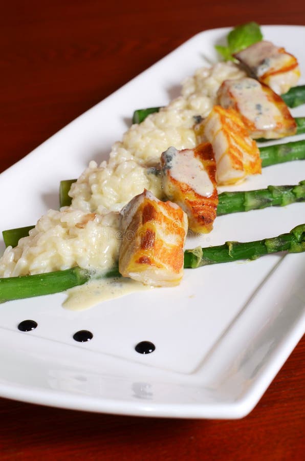 Tagliata from a sturgeon with an asparagus and risotto