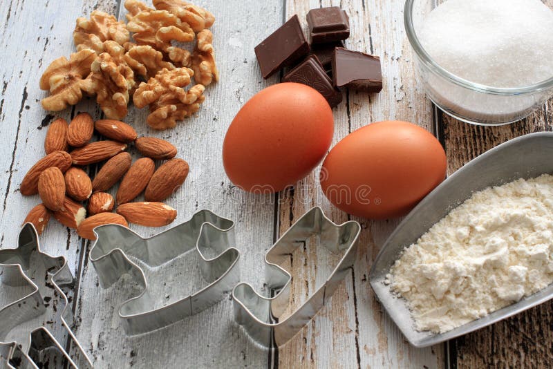 Taglierine del biscotto di Natale con gli ingredienti di cottura immagini stock Taglierine del biscotto di Natale con gli ingredienti di cottura immagini stock