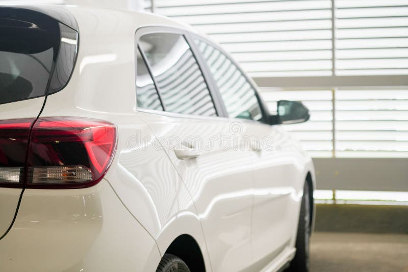 Tail Lights of the White Car Parked in the Lot, Back View, Closeup
