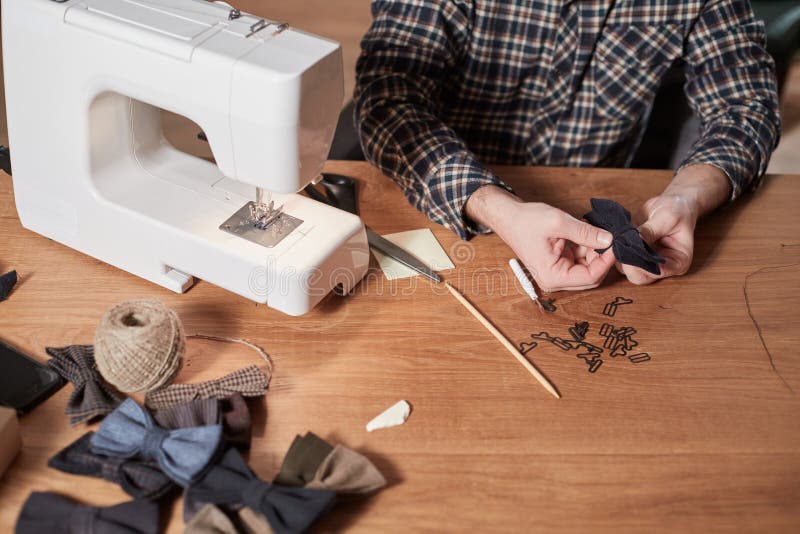 Tailor Makes Bow Ties of Woolen Fabric. Work with Sewing Machine in a