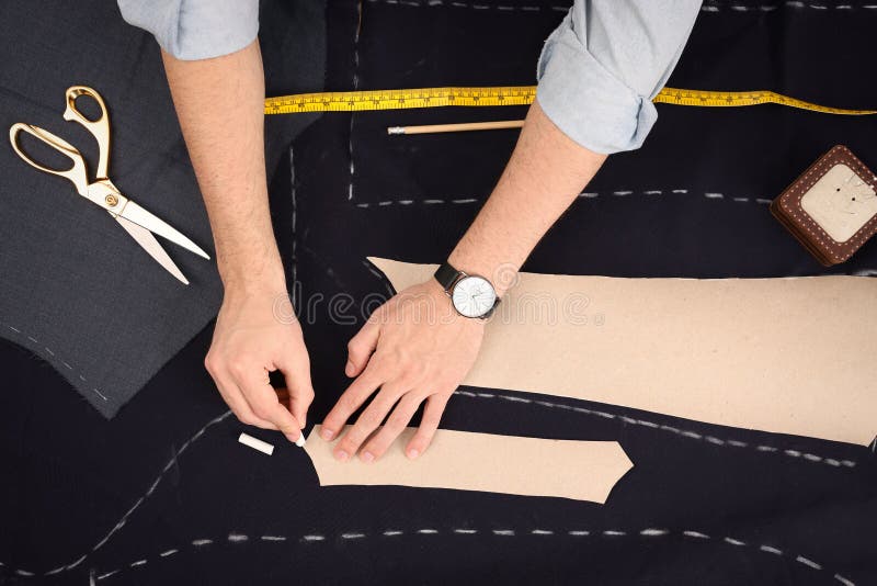 Tailor Marking Sewing Pattern on Fabric with Chalk at Table, Top View