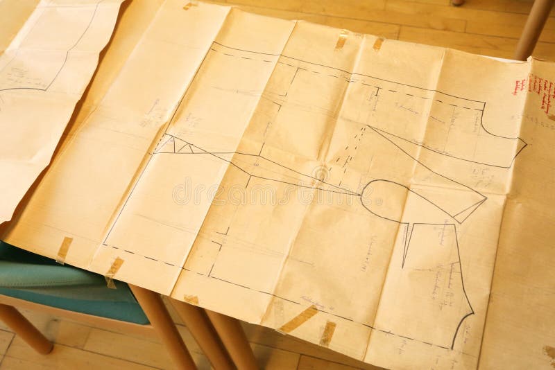 A tailor's pattern for cutting material on a paper sheet. A tailor's pattern for cutting material on a paper sheet.