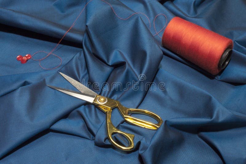 tailor`s scissors of gold color on fabric. seamstress. View from above stock image tailor`s scissors of gold color on fabric. seamstress. View from above stock image