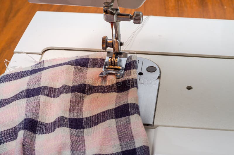 Tailor Sews Fabric for Clothing on a Sewing Machine in a Tailor Shop