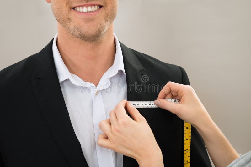 Tailor taking measurement of coat royalty free stock photos