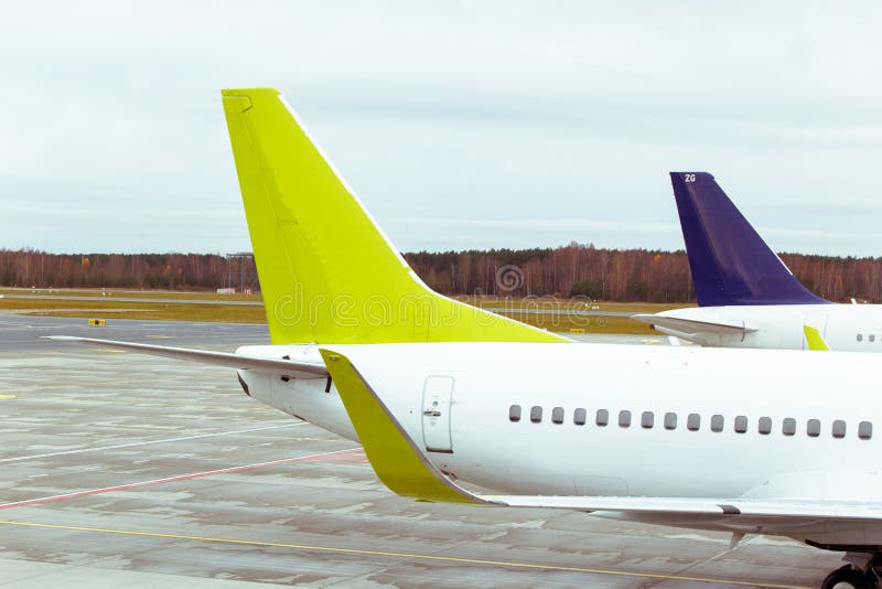 Tails of some airplanes at airport. Travel and transportation concepts. stock photo Tails of some airplanes at airport. Travel and transportation concepts. stock photo