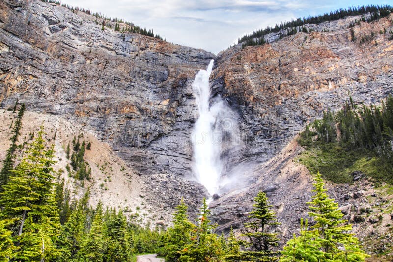 Powerful Takakkaw Falls in Yoho National Park near Field, British Columbia, Canada. The Glacier-fed waterfall is one of the tallest waterfalls in Canada. Powerful Takakkaw Falls in Yoho National Park near Field, British Columbia, Canada. The Glacier-fed waterfall is one of the tallest waterfalls in Canada.