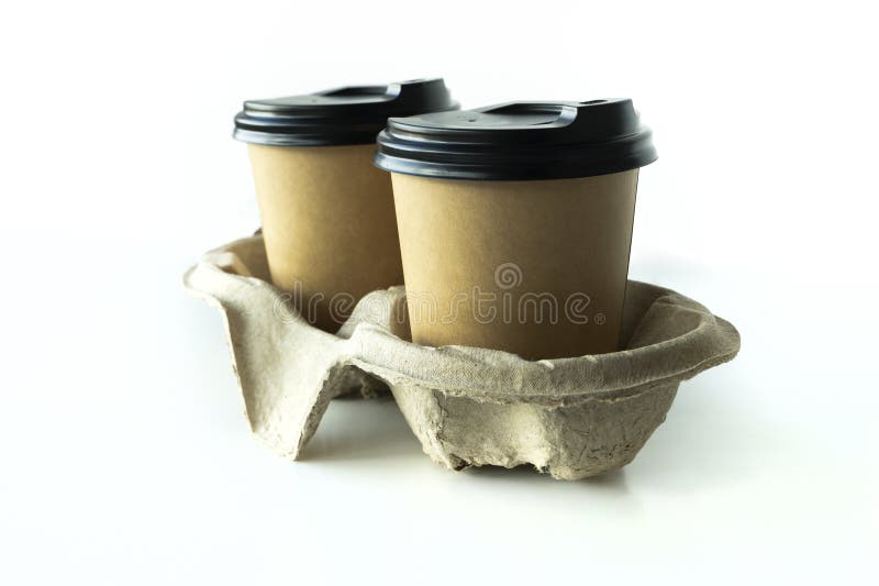 Takeaway paper coffee cups with plastic lids and cardboard holder royalty free stock image