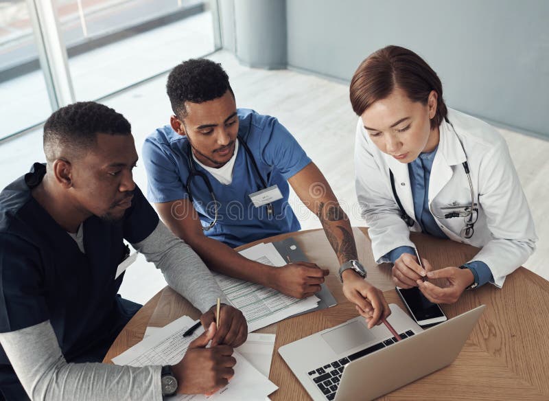 It takes two flints to make a fire. Shot a group of doctors discussing work matters in the office at work. royalty free stock images