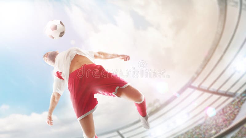 Taking the ball on the chest in football. Close ups. The soccer player is jumping to hitting soccer ball with chest.
