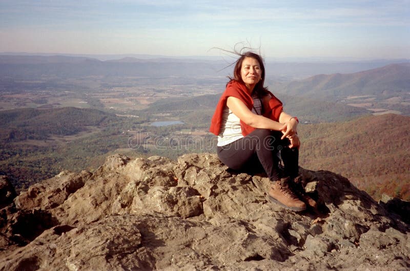 Photo of hispanic mexican woman resting on the top of stoney man mountain at skyline drive virginia during autumn. Photo of hispanic mexican woman resting on the top of stoney man mountain at skyline drive virginia during autumn.