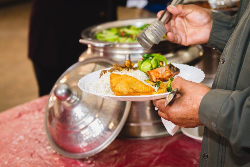 Taking food from Buffet stock photo. Image of hand, food 109177766