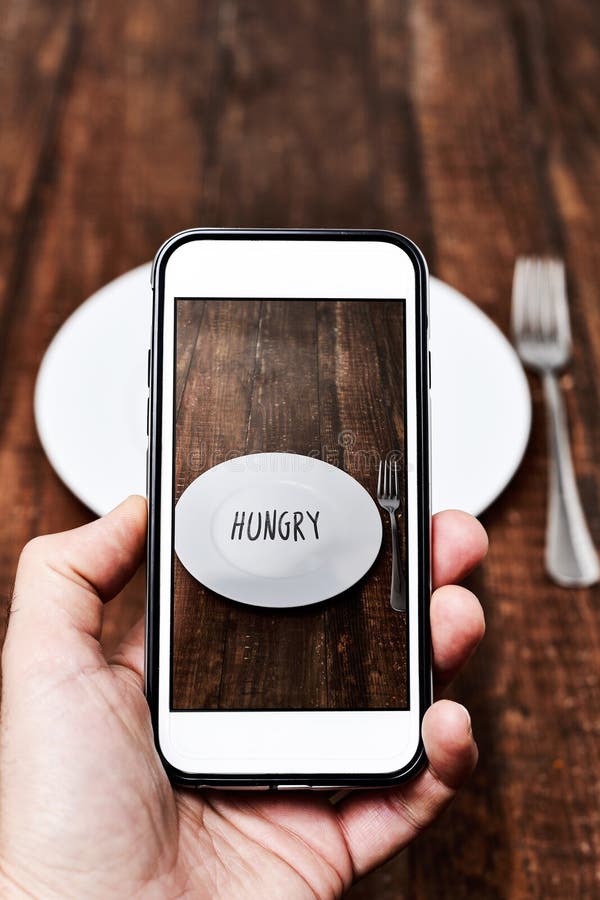 Taking a picture of a plate with the word hungry royalty free stock photography Taking a picture of a plate with the word hungry royalty free stock photography