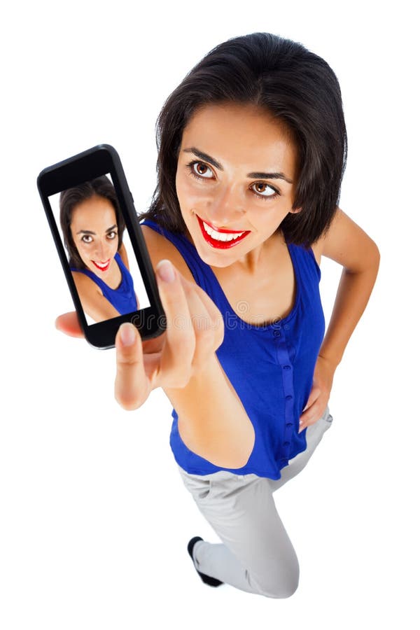 Beautifully smiling cute girl taking self portrait with her phone - mobile sexting . Beautifully smiling cute girl taking self portrait with her phone - mobile sexting .