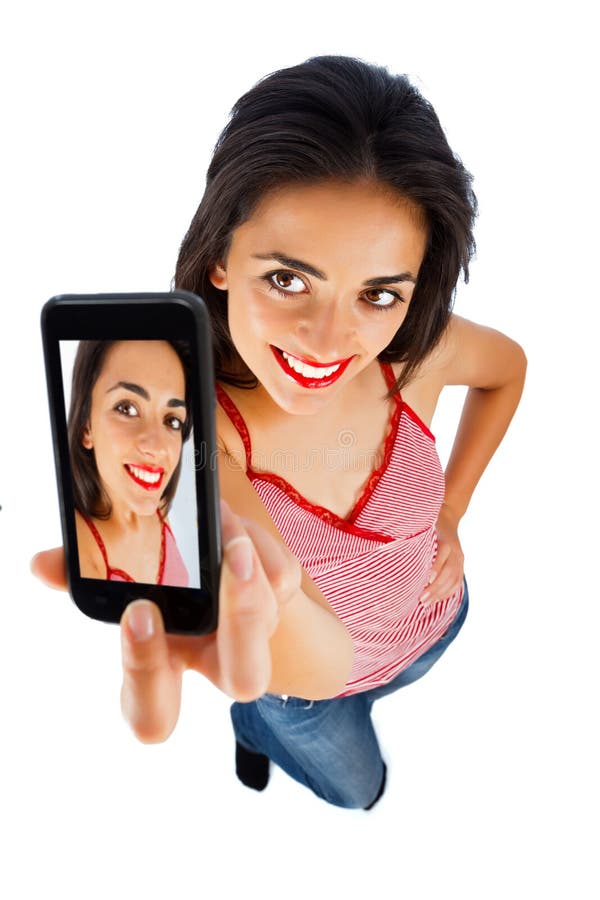 Cute girl with red lipstick taking selportrait with phone - isolated on white. Cute girl with red lipstick taking selportrait with phone - isolated on white.