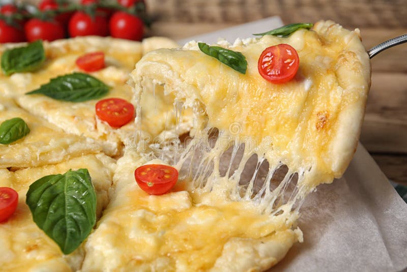 Taking tasty homemade pizza slice with melted cheese stock photography Taking tasty homemade pizza slice with melted cheese stock photography