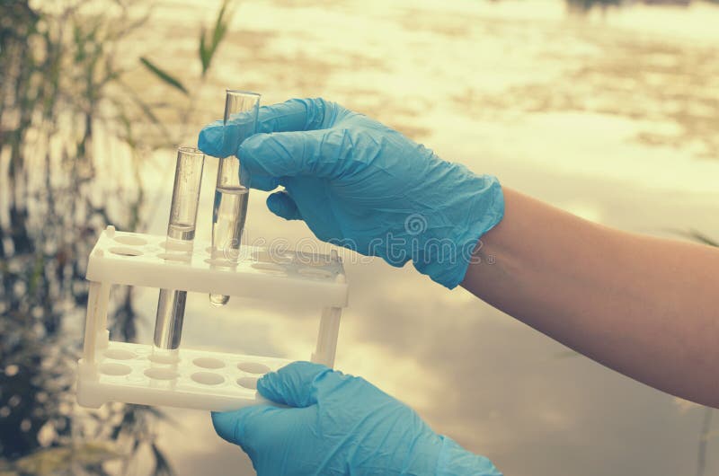 Taking a Water Test for Analysis from a Reservoir. Stock Photo Image