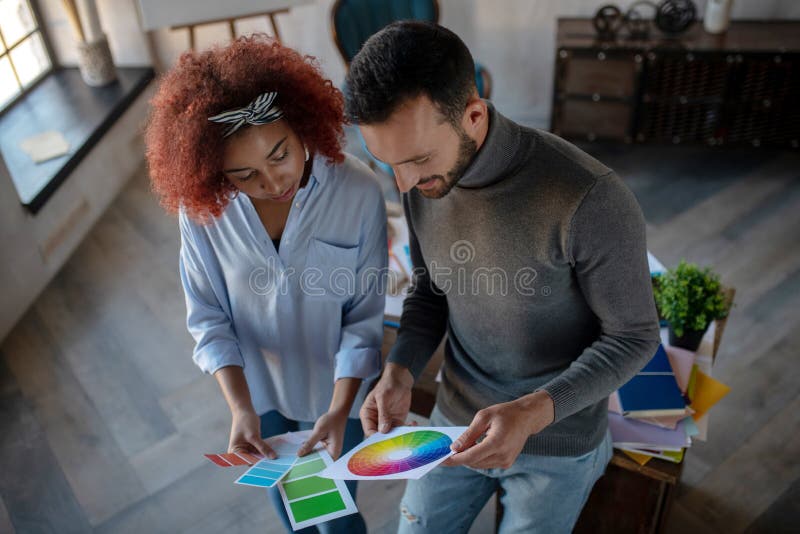 Two talented interior designers choosing color for project royalty free stock images