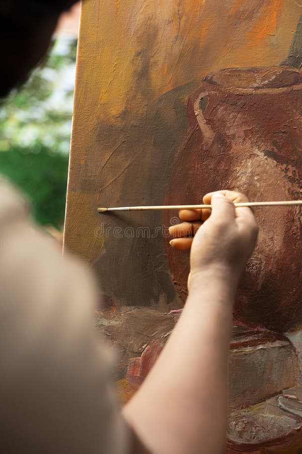 Talented painter creating a colorful painting with watercolors on a canvas royalty free stock photo