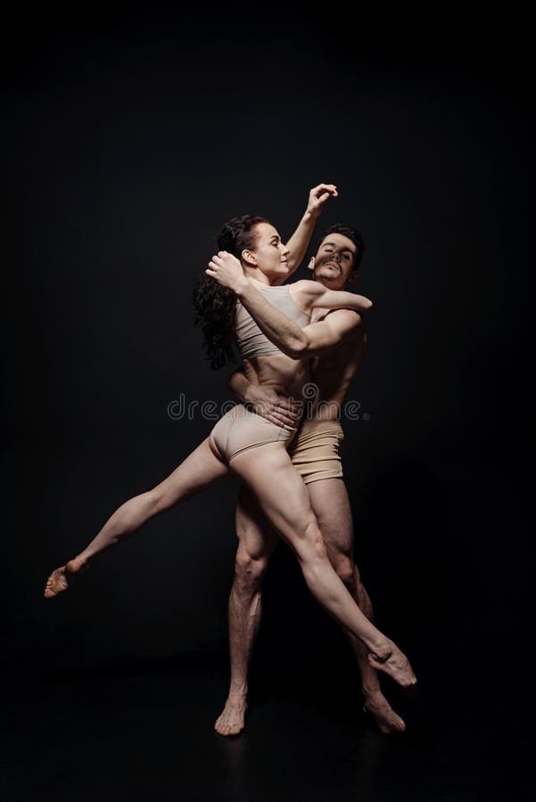 Talented performers dancing isolated in black background stock images