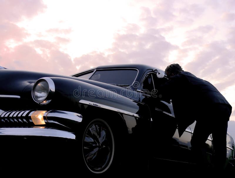 Two guys talking cars by a black american car on a power meet. Two guys talking cars by a black american car on a power meet