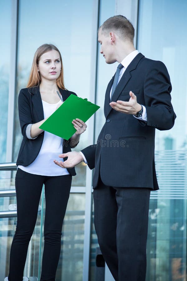 Talking in front of business building