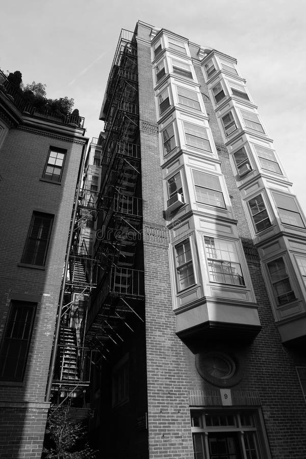 Tall building with fire escape and bay windows