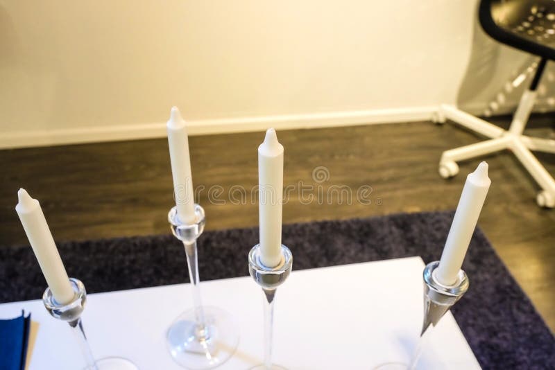 Tall Candleholders with Thin Candles in Them Stand on Dinner Table