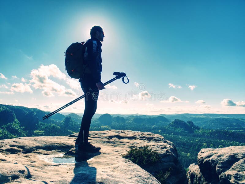 Tall man taking an excursion on a mountain. Mountain hiker