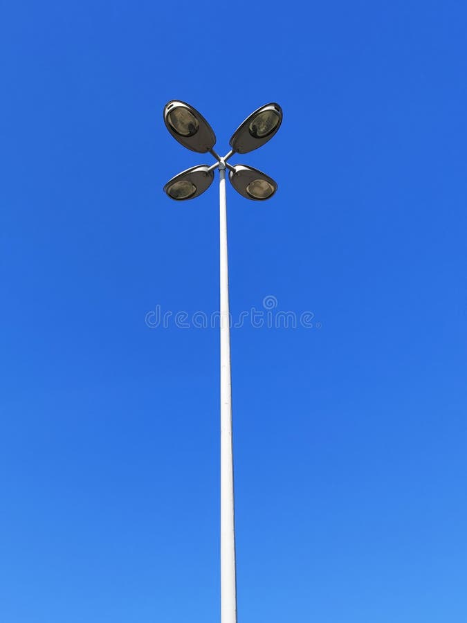 Tall Street Lights Hanging on the Metal Pole Front of the Blue Sky