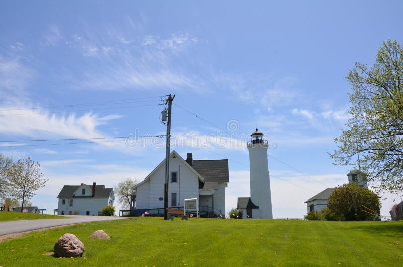 Tall white lighthouse building and blue sky Tibbetts Point royalty free stock image