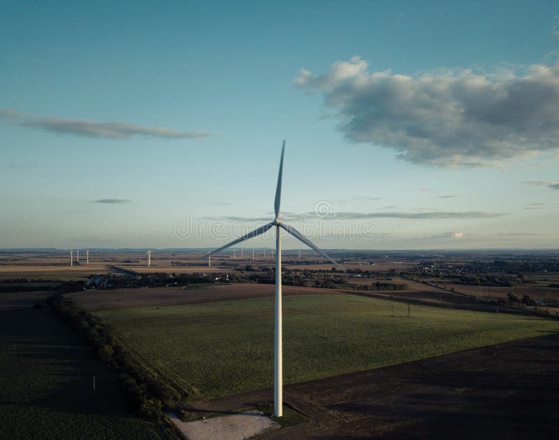 Tall Wind Turbine in a Green Field Wind Energy Stock Photo Image of