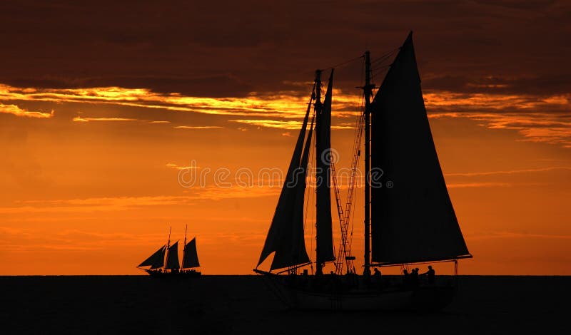 Color photo of sailboats against sunset. Color photo of sailboats against sunset