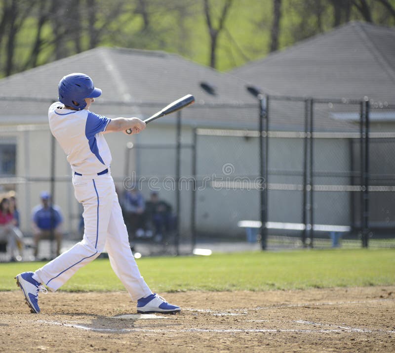 Teenage high school baseball batter swinging. Teenage high school baseball batter swinging