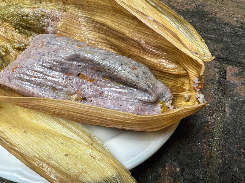Tamale Made with Blue Corn and Squash Blossom, Wrapped in a Corn Husk