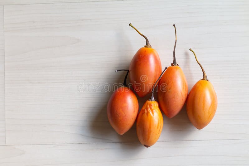 Tamarillo fruit on the table. The tamarillo is a small tree or shrub in the flowering plant family Solanaceae the nightshade family. It is best known as the royalty free stock photography Tamarillo fruit on the table. The tamarillo is a small tree or shrub in the flowering plant family Solanaceae the nightshade family. It is best known as the royalty free stock photography