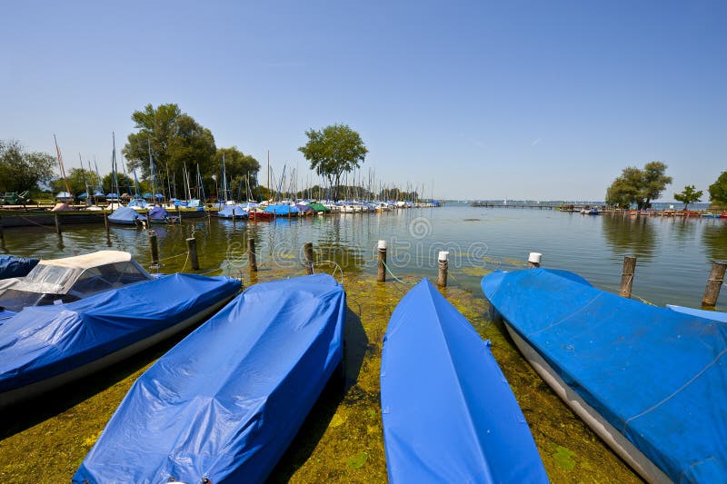 Tarpaulin Covers for Boats, the Lake Chiemsee in Bavaria. Tarpaulin Covers for Boats, the Lake Chiemsee in Bavaria