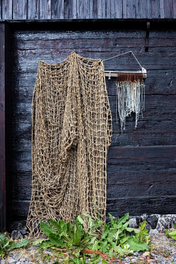 Fishing Net Draped Loosely Alongside a Row of Big Game Fish Hooks Stock  Image - Image of drying, dark: 170219763