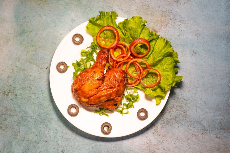 Tandoori Chicken Platter with Lime and Salad in a Dish Top View of