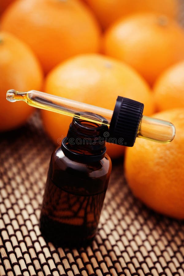 Tangerine Essential Oil. Mandarin Orange Oil on Glass Bottle with