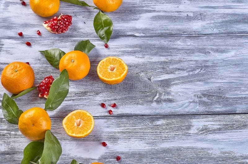 Tangerines with leaves on a wooden background