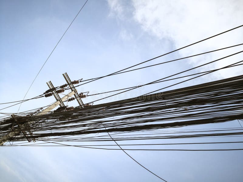 Tangle of Electrical Cables and Communication Wires on Electric Pole