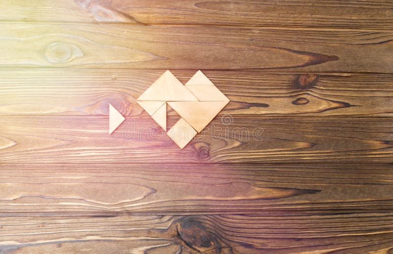 Tangram puzzle wait for fulfill to heart shape on wooden table