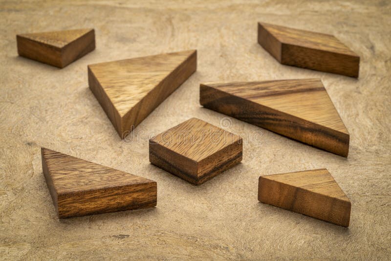 Tangram wooden pieces, a traditional Chinese puzzle game, texture bark paper background royalty free stock photo