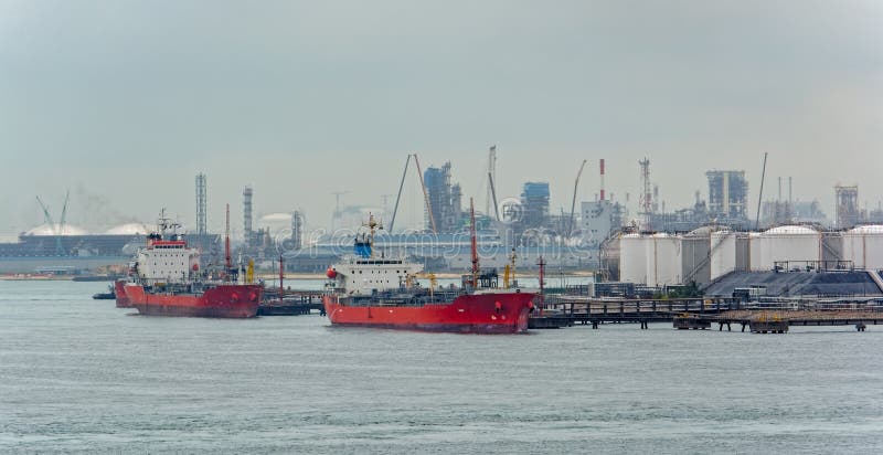 Tanker in front of an oil refinery plant stock photos Tanker in front of an oil refinery plant stock photos