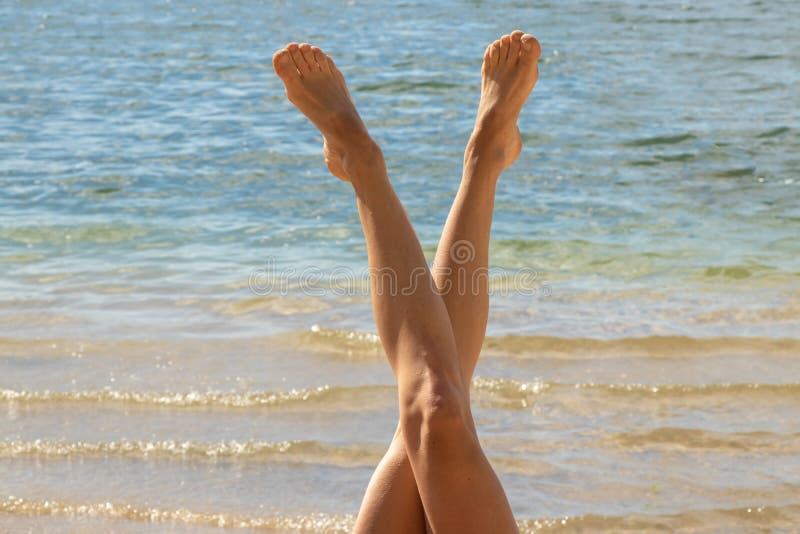 Tanned legs of a young girl on a background of water in the shape of a letter v in summer. Tanned legs of a young girl on a background of water in the shape of a royalty free stock images Tanned legs of a young girl on a background of water in the shape of a letter v in summer. Tanned legs of a young girl on a background of water in the shape of a royalty free stock images