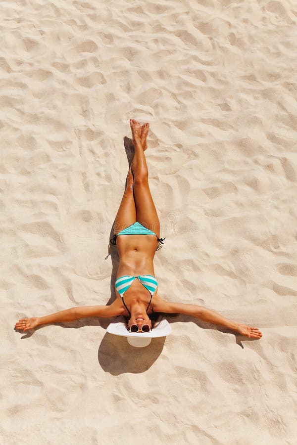Tanned young woman in bikini on beach sand royalty free stock photography Tanned young woman in bikini on beach sand royalty free stock photography